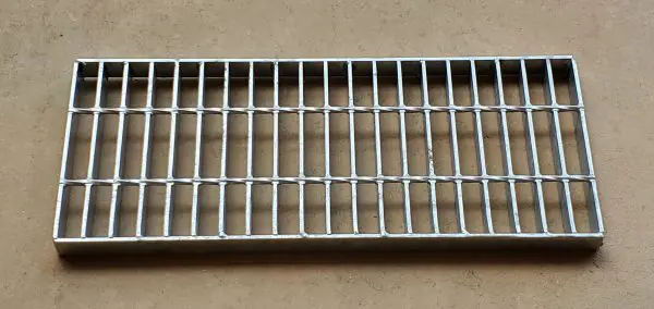 A metal grate sitting on top of a floor.