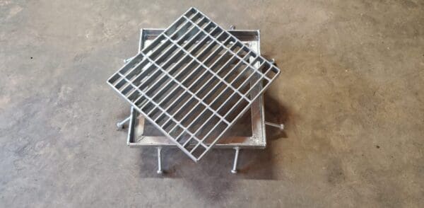 A metal grate sitting on top of a floor.