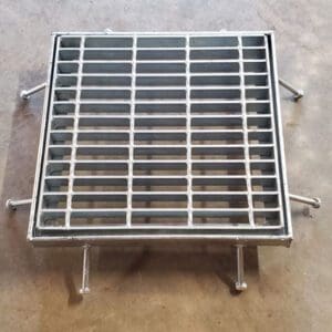 A metal grate sitting on top of the ground.