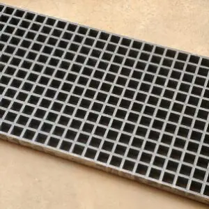 A close up of the bottom of a metal grate.