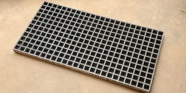 A close up of the bottom of a metal grate.