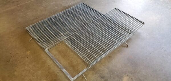 A metal grate sitting on top of the floor.