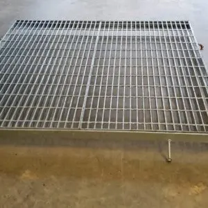 A metal grate sitting on top of the floor.