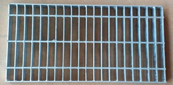 A close up of the bottom of a metal grate