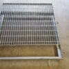 A metal grate sitting on top of the floor.
