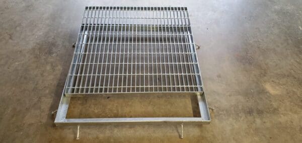 A metal grate sitting on top of the floor.