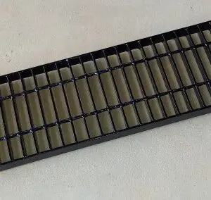 A black tray with many small bars on it