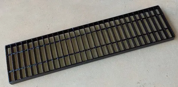 A black plastic tray with some brown squares on it