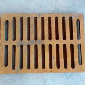 A brown grate sitting on top of a floor.