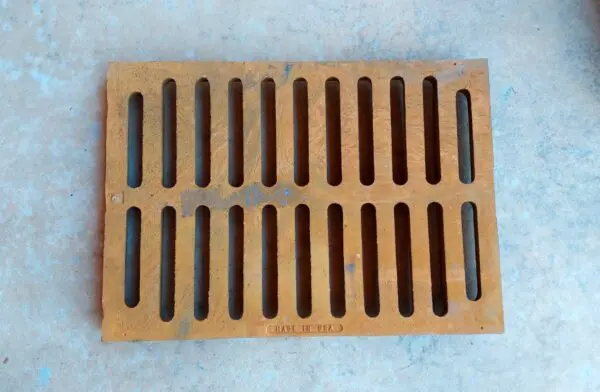 A brown grate sitting on top of a floor.