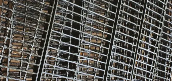 A close up of metal grate on the side of building.