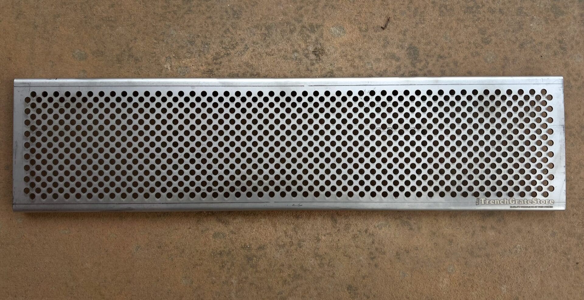 A metal grate with black dots on it.