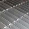 A close up of the bottom of a metal grate.