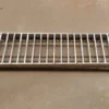 A metal grate sitting on top of the floor.