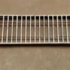 A metal grill is shown on the wall.
