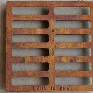 A rusty metal grate with the made in usa logo.
