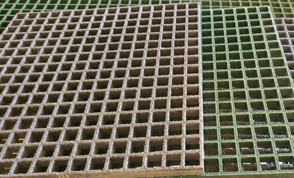 A close up of two different grates on the ground