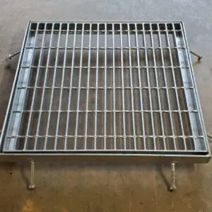 A metal grate sitting on top of the floor.