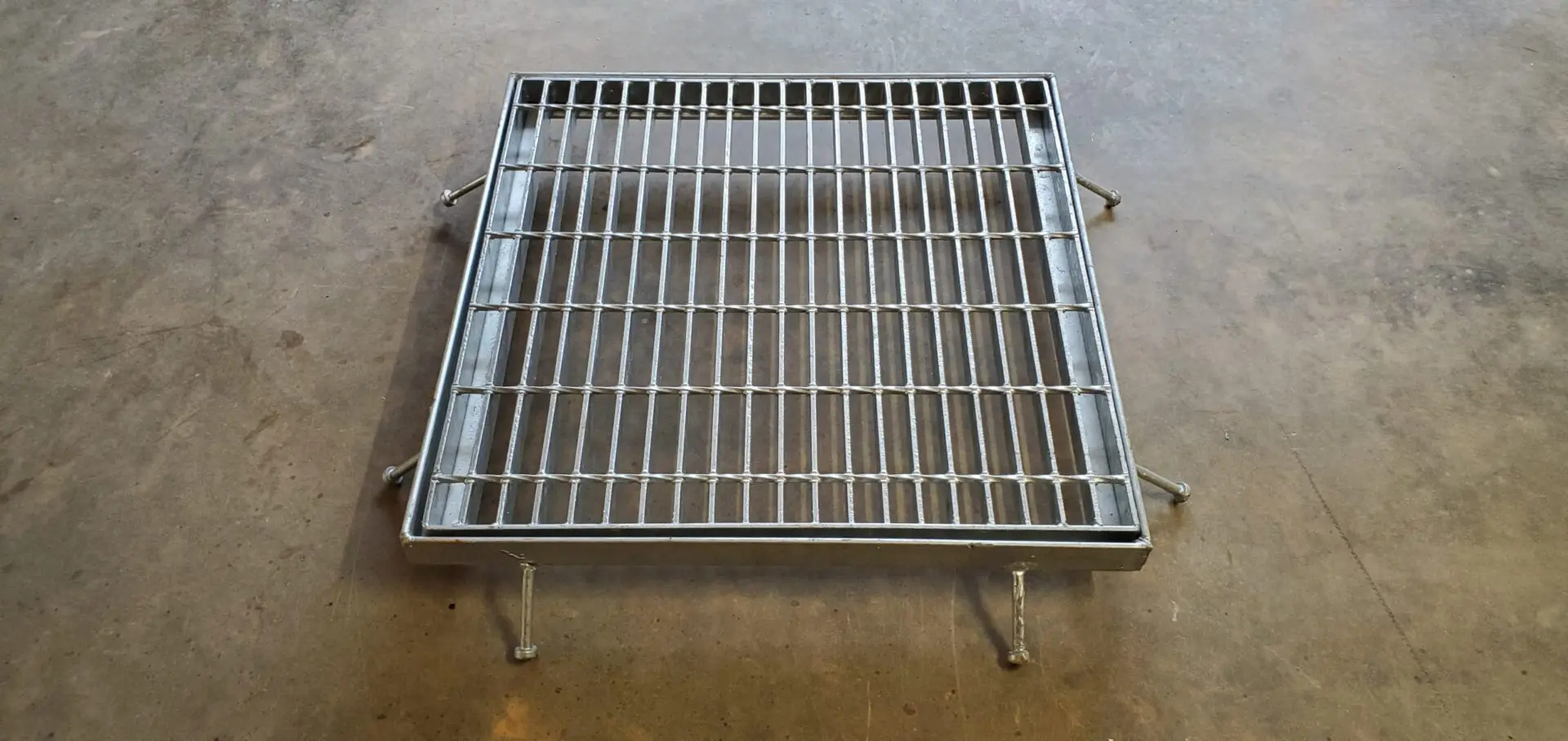 A metal grate sitting on top of the floor.