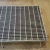 A metal grate sitting on top of the floor.