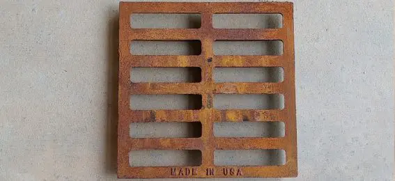 A rusty metal grate with the made in usa logo.