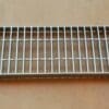 A metal grate sitting on top of a table.