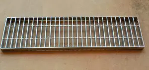 A metal grate sitting on top of a table.