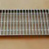 A metal grate sitting on top of a table.