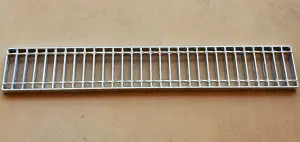 A metal grate sitting on top of a floor.