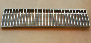 A metal grate sitting on top of a floor.