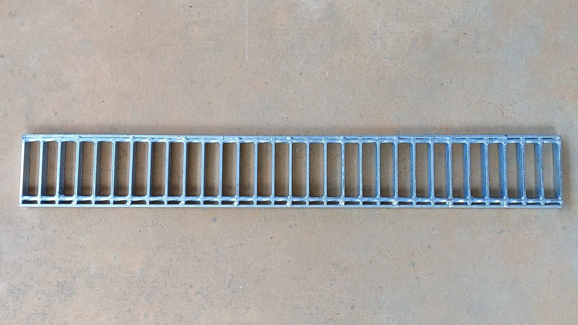 A metal grate that is on the ground.