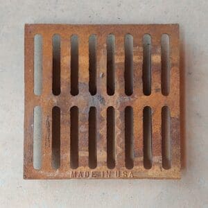 Rusty metal drain grate, Made in USA.