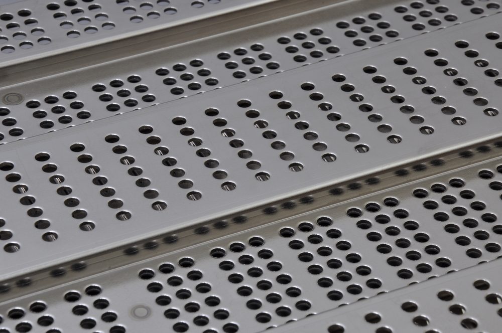 perforated trench grates stacked on top of each other