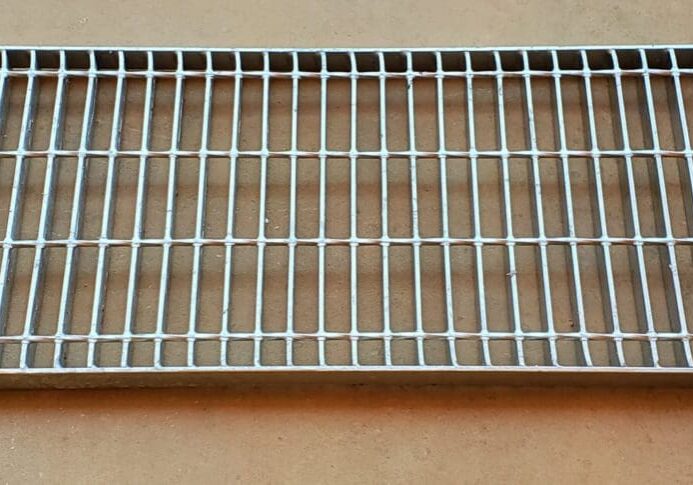 A metal grate sitting on top of a floor.