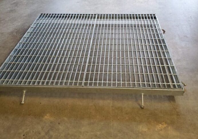 A metal grate sitting on top of the floor.