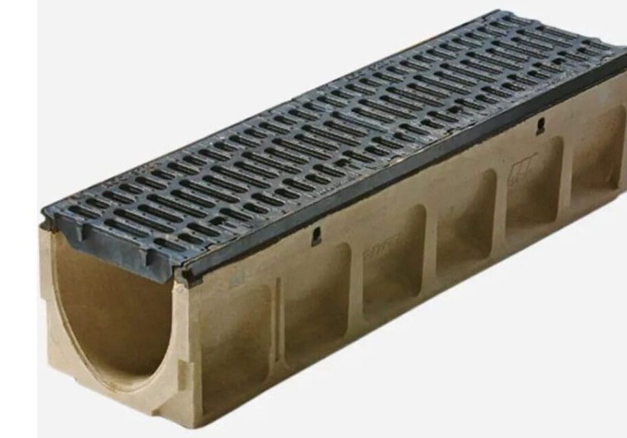 A long concrete trench drain with a plastic grate.