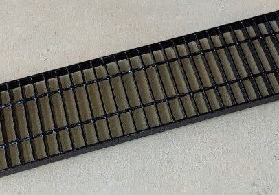 A black tray with many small bars on it