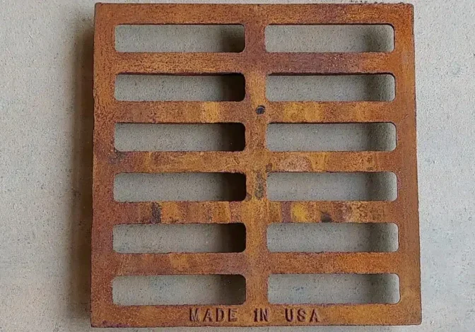 A rusty metal grate with the made in usa logo.