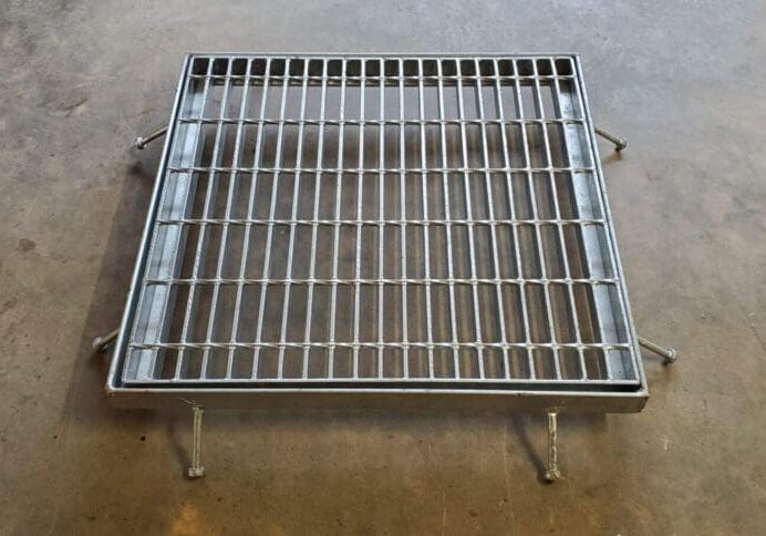 A metal grate sitting on top of the floor.