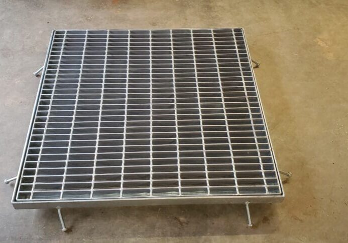Metal grate drain cover on concrete.