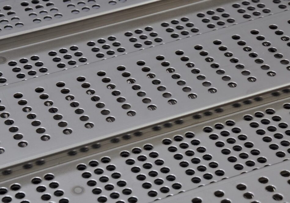 perforated trench grates stacked on top of each other